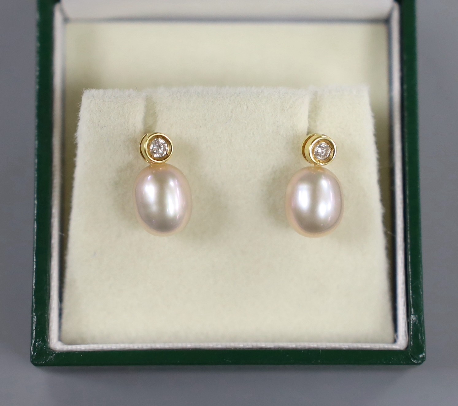 A modern pair of 18ct gold, cultured pearl and diamond set ear studs, 12mm, gross weight 2.3 grams.